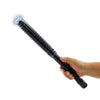 In‑hand view of the Attitude Adjuster stun baton with the flashlight on, highlighting the control buttons and ergonomic handle.