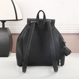 Black concealed‑carry backpack with its hidden firearm compartment open, showing the holster pocket and attached securing straps.