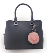 Soft pink furball personal alarm attached to a purse strap via keyring, branded as an SDP Inc. exclusive.