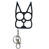 black cat‑shaped metal self‑defense keychain displayed with cutout eye holes and pointed ear design