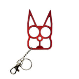 red cat‑shaped metal self‑defense keychain displayed with cutout eye holes and pointed ear design