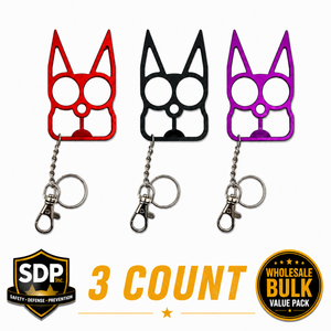 Three cat‑shaped self‑defense keychains in assorted colors displayed together, showing the pointed ear impact tips and dual finger‑grip eye holes.