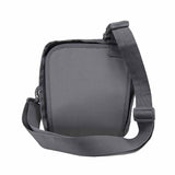 Concealed‑carry satchel shown with its shoulder strap visible beside the hidden firearm compartment, highlighting the reinforced holster pocket.