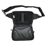 Interior of a black concealed‑carry fanny pack with holster section, accessory dividers, and full‑zip opening.
