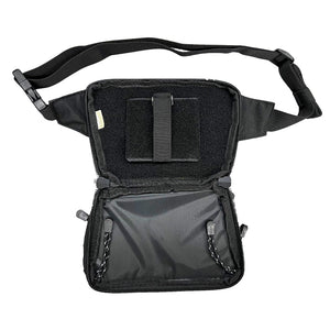Interior of a black concealed‑carry fanny pack with holster section, accessory dividers, and full‑zip opening.