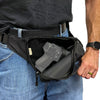 Concealed‑carry fanny pack worn at the waist with the pull‑string activated, showing the rapid‑access opening motion.