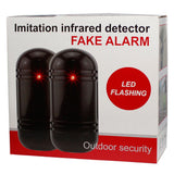 Retail packaging showing two imitation infrared security beam detectors inside a clear blister pack with branding and feature highlights.