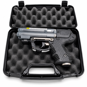Firestorm JPX 6 black pepper spray gun with integrated laser shown inside its hard carry case with molded interior compartments.