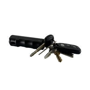 Compact pepper gel spray connected to a keychain, displayed with multiple keys attached.