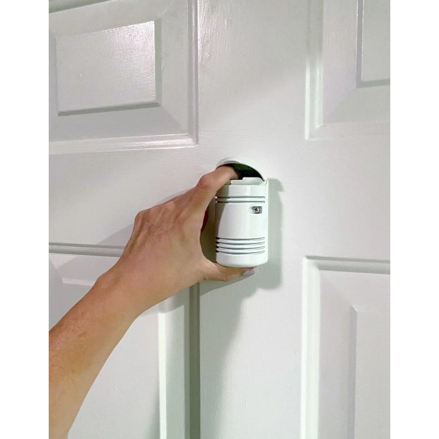 Guardian Angel Home Defender door-mounted pepper spray security system with active and training canisters for home protection.