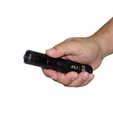 Jolt tactical stun gun flashlight held in a person’s hand, showing its rugged body and forward electrode area.