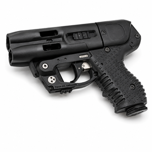 JPX 4 Compact C2 LE black pepper spray gun with integrated laser shown laying flat, highlighting its compact frame and dual‑barrel design.