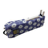 Ladies Choice Daisy stun gun shown with its built‑in charge plug extended from the base of the device.
