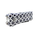 Close view of the navy Ladies Choice stun gun featuring a repeating quatrefoil motif on its casing.