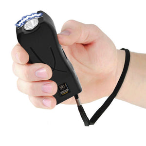 Black Life Guard stun gun held in a person’s hand, showing its compact rectangular body and front contact points.