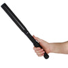 Lightning Rod stun baton shown held in a person’s hand, highlighting its long textured grip, front electrode prongs, and built‑in flashlight head.