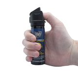 Police Force 3‑ounce pepper foam spray shown in hand to display size, grip, and actuator placement.