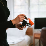 Close‑up of the SABRE Aim & Fire pepper gel device as the replacement cartridge is loaded into the trigger‑grip mechanism.