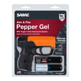 SABRE Aim & Fire pepper gel trigger‑grip unit shown in its retail packaging with product branding and safety details