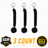 Three sap‑style monkey fist self‑defense keychains displayed together, each featuring a tightly wrapped cord ball attached to metal.