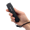 Black Serpent stun gun shown held in a person’s hand, highlighting its curved ergonomic body and front electrode area.