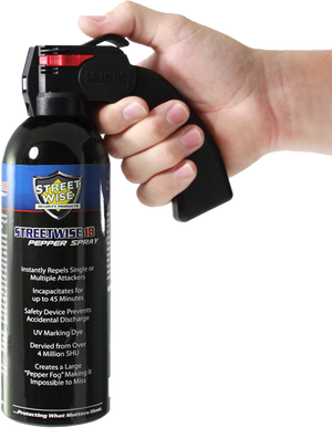Streetwise 18 fogger pepper spray (16‑oz) with pistol‑grip handle shown in hand to display size, grip, and control.