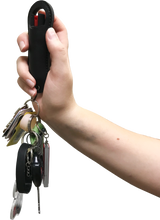 Compact 0.5‑oz Streetwise 18 stream pepper spray in halo case displayed with keys attached to the integrated key ring.