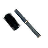Open‑position view of the Streetwise hair‑dryer brush stun gun highlighting the internal contact points and safety switch.