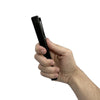 Black Hot Rod stun gun gripped in a hand, highlighting the dual‑light front end and textured ergonomic handle.
