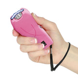 Pink Streetwise Lifeguard stun gun held in hand, showing its compact grip and easy‑access activation switch.