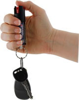 Streetwise stream pepper spray shown with safety‑lock actuator and attached key ring with keys.