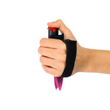 Magenta Strike‑N‑Spray Double Defender shown in hand to display size, grip, and dual‑function design.