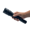 rechargeable tactical stun flashlight with a durable black metal body and integrated stun feature bwing held in hand