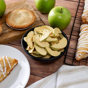 freeze‑dried apples served in a bowl, shown alongside long‑shelf‑life survival‑food packaging for emergency preparedness