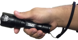 black flashlight with textured grip held in hand