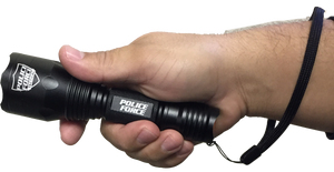 black flashlight with textured grip held in hand