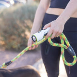 “Person walking a dog while carrying the TASER StrikeLight 2 in hand.”