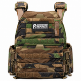 Testudo Gen 3 plate carrier in woodland camouflage shown with laser‑cut MOLLE, padded shoulder straps, and adjustable cummerbund for tactical loadouts.