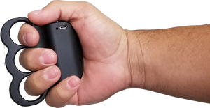 Triple Sting Ring stun gun shown held in a person’s hand, highlighting its circular grip and activation button placement.