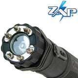 Front view of the ZAP Light Extreme stun gun flashlight showing the spiked metal electrodes surrounding the light lens.