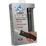 Retail packaging for the ZAP Light Extreme stun gun flashlight showing the device with spiked electrodes, branding, and listed features on the front of the box.