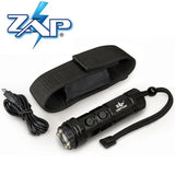 Contents layout showing the ZAP Light Mini stun gun flashlight, charging cable, wrist strap, and included accessories arranged on a flat surface.