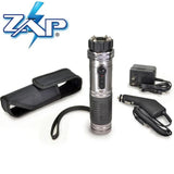 Contents layout showing the ZAP Light stun gun flashlight, charging cable, wrist strap, and included accessories arranged on a flat surface.